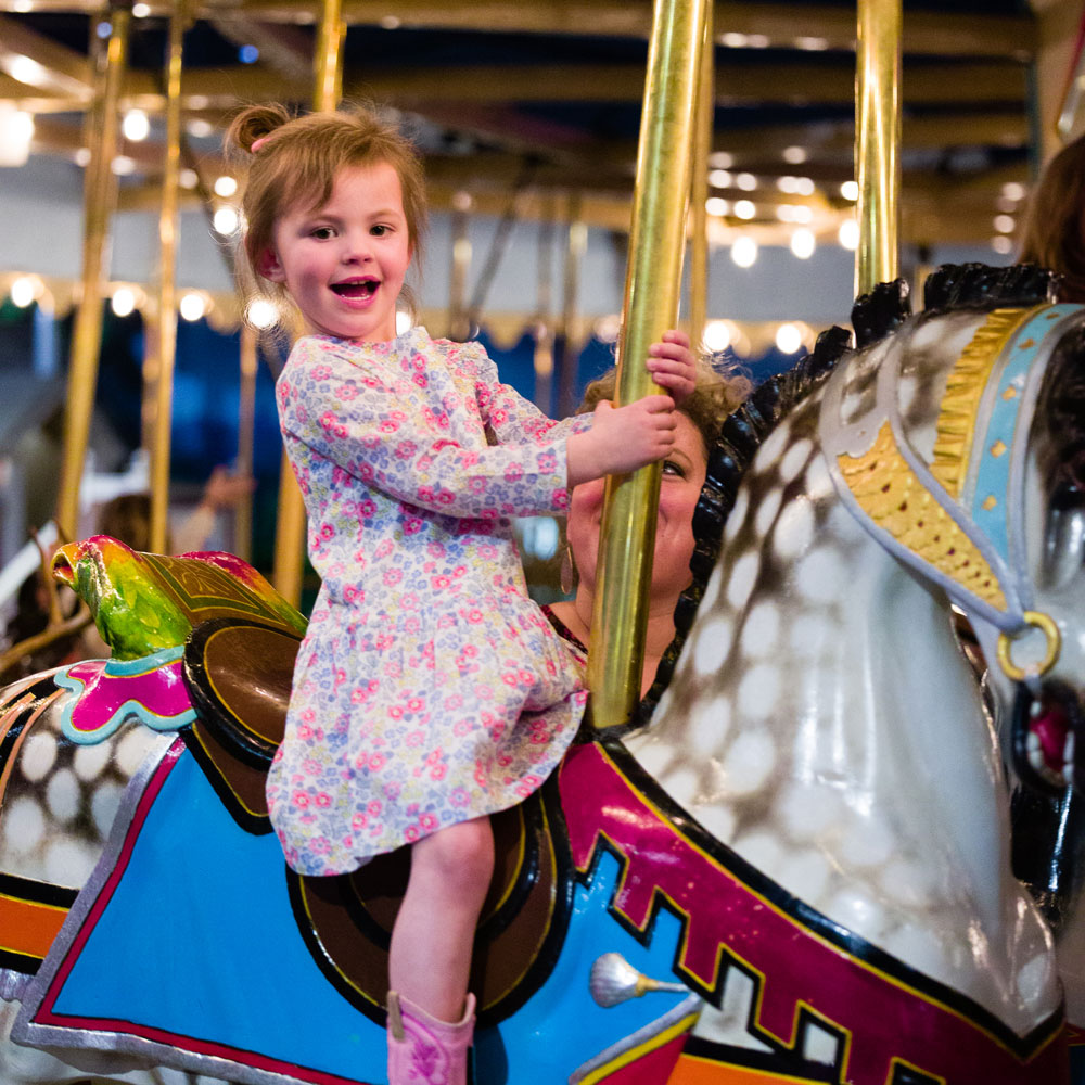 Young girl riding the Carousel.